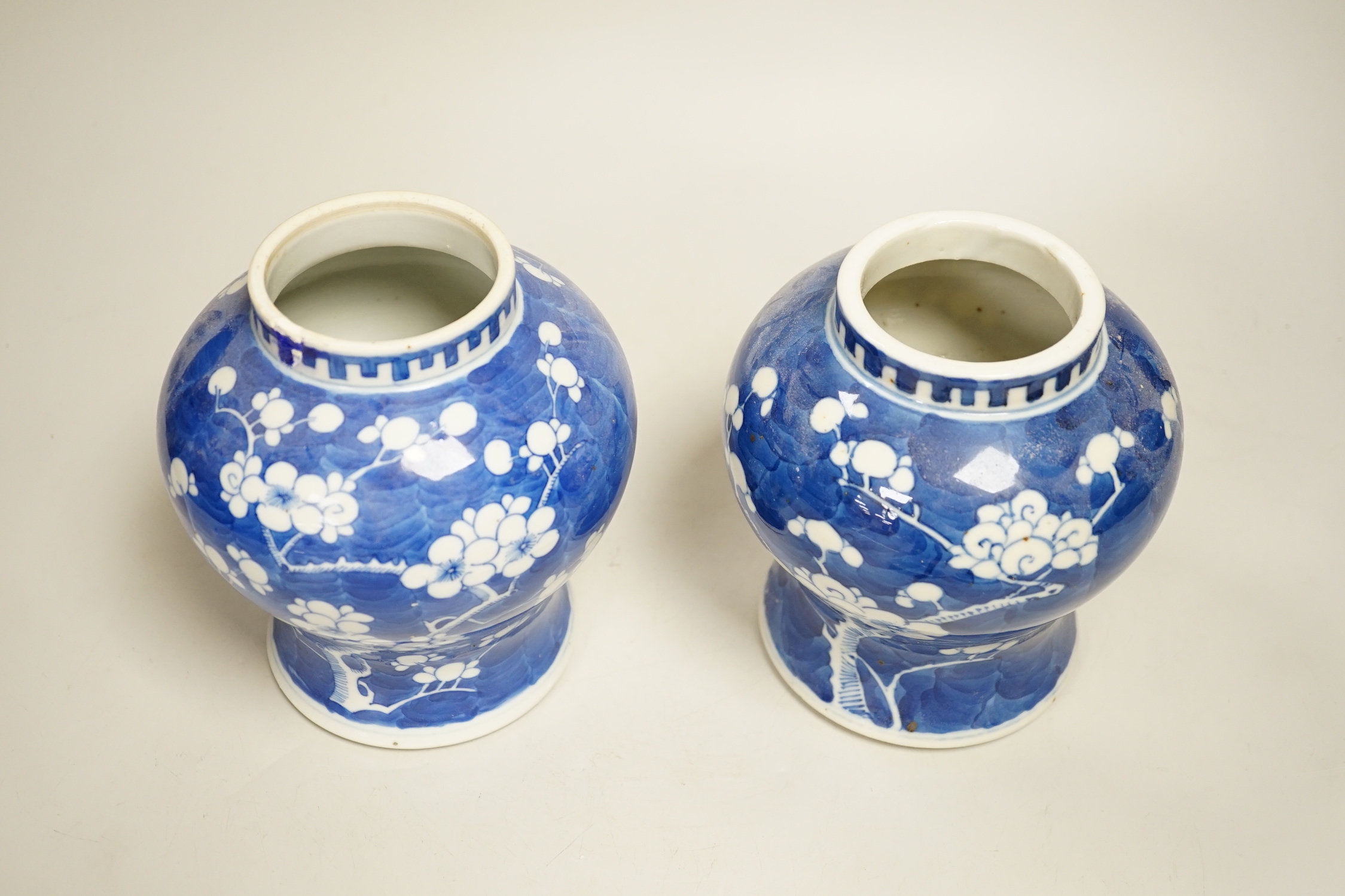 A pair of Chinese blue and white prunus pattern vases and covers, 21cm high